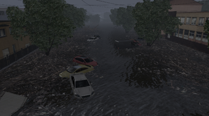 Flooded cars in the roadway.