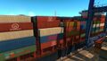 Containers aboard a docked cargo ship